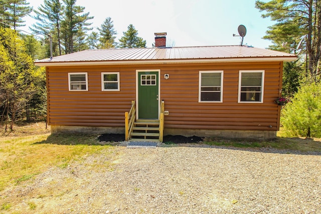 342 Spring Bridge Rd, Greenbush, ME 04418 - back of property with entry steps, a chimney, and metal roof