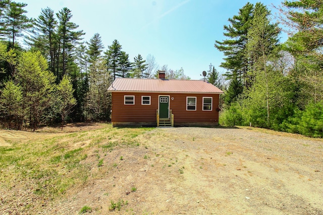 342 Spring Bridge Rd, Greenbush, ME 04418 - view of front of home featuring entry steps, a chimney, metal roof, and log veneer siding