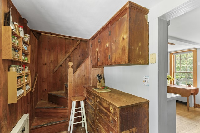 42 Winthrop St, Hallowell, ME 04347 - stairway featuring wood finished floors, wooden walls, and radiator