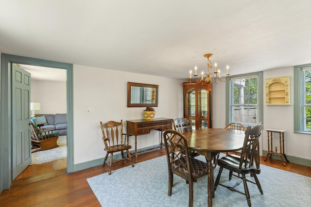 42 Winthrop St, Hallowell, ME 04347 - dining space with wood finished floors, a chandelier, and baseboards