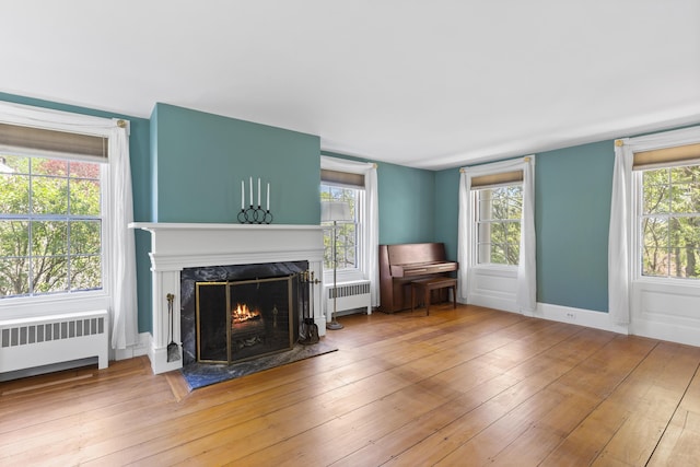 42 Winthrop St, Hallowell, ME 04347 - living room with radiator heating unit, a premium fireplace, hardwood / wood-style floors, and baseboards