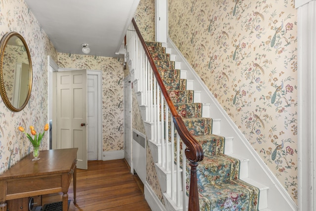 42 Winthrop St, Hallowell, ME 04347 - staircase featuring wallpapered walls, wood finished floors, and baseboards
