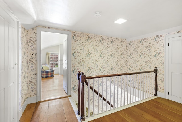 42 Winthrop St, Hallowell, ME 04347 - hallway featuring an upstairs landing, wallpapered walls, hardwood / wood-style flooring, baseboards, and vaulted ceiling