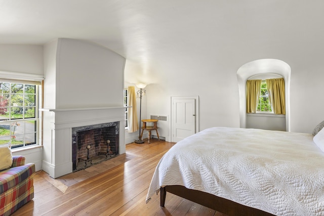 42 Winthrop St, Hallowell, ME 04347 - bedroom with hardwood / wood-style floors, a fireplace, radiator, and baseboards