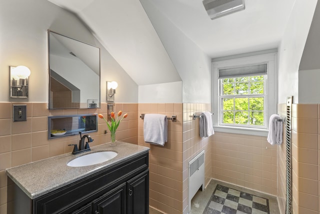 42 Winthrop St, Hallowell, ME 04347 - bathroom with tile walls, vanity, radiator heating unit, a wainscoted wall, and tile patterned flooring