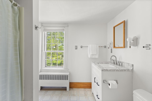 42 Winthrop St, Hallowell, ME 04347 - full bath featuring radiator, vanity, toilet, tile patterned floors, and a shower with curtain