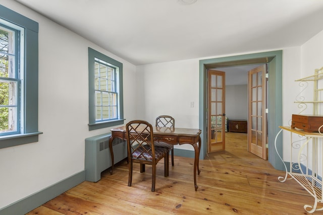42 Winthrop St, Hallowell, ME 04347 - dining room with light wood-style floors, french doors, healthy amount of natural light, and radiator heating unit