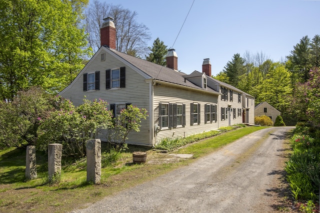 42 Winthrop St, Hallowell, ME 04347 - view of home's exterior with a chimney and driveway