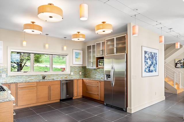 39 Kendall Farm Trl, Rangeley, ME 04970 - kitchen with appliances with stainless steel finishes, backsplash, light stone counters, and pendant lighting