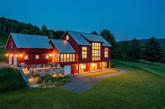 39 Kendall Farm Trl, Rangeley, ME 04970 - back of property with a garage, driveway, a lawn, and a metal roof