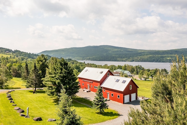 39 Kendall Farm Trl, Rangeley, ME 04970 - view of mountain backdrop featuring a forest and a nearby body of water