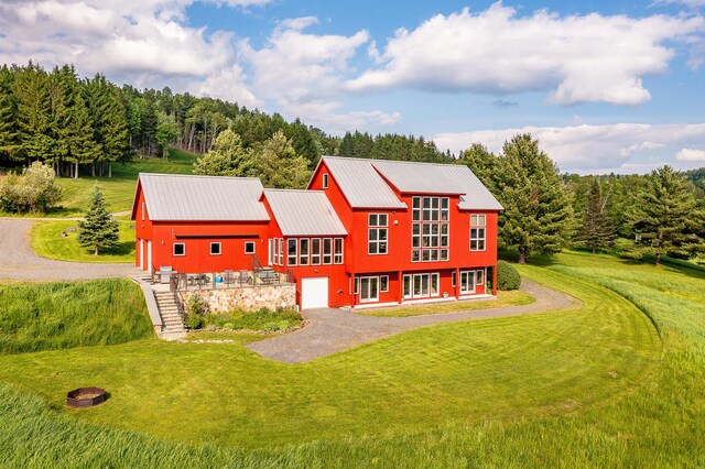 39 Kendall Farm Trl, Rangeley, ME 04970 - view of front facade with driveway, a front yard, and a metal roof