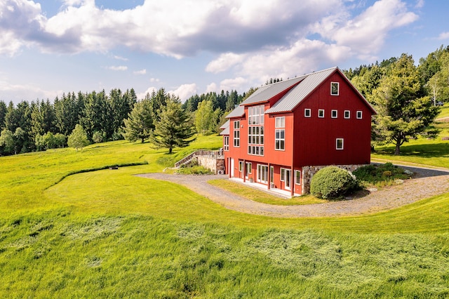 39 Kendall Farm Trl, Rangeley, ME 04970 - view of side of home with a yard and a metal roof
