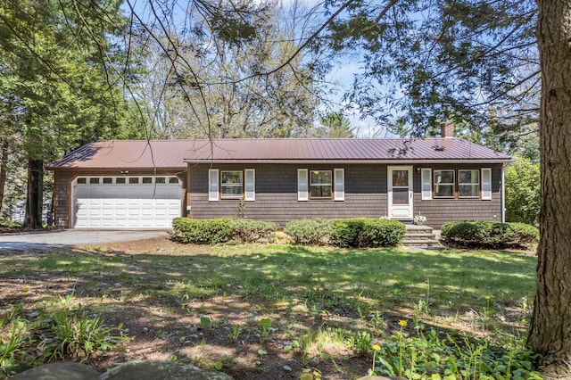 view of front facade with a garage, a chimney, metal roof, a front lawn, and driveway