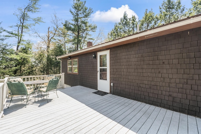 wooden terrace with outdoor dining space