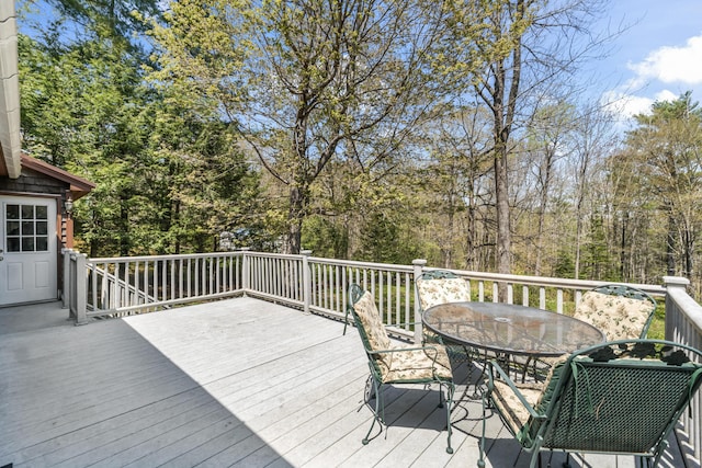 wooden terrace with outdoor dining area
