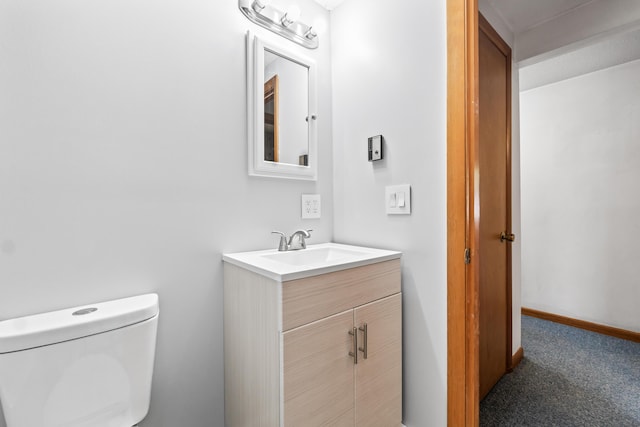 half bathroom featuring toilet and vanity