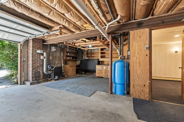 below grade area with heating fuel, a baseboard radiator, and a water pressure tank