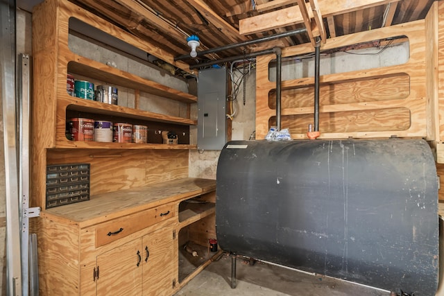 unfinished below grade area featuring oil tank and electric panel
