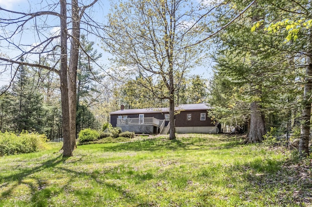 view of grassy yard featuring a deck