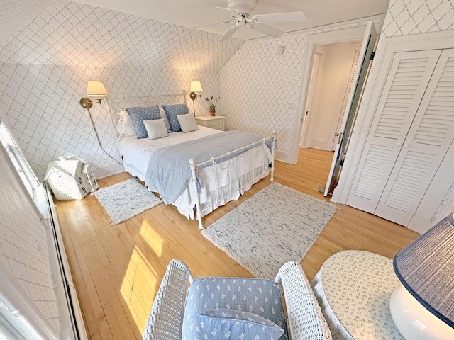 bedroom featuring wood finished floors, ceiling fan, and baseboards