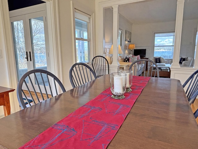 dining area with decorative columns and french doors