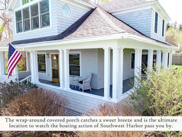 view of side of home with a porch and roof with shingles