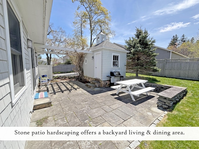 view of patio with a fenced backyard and an outdoor structure