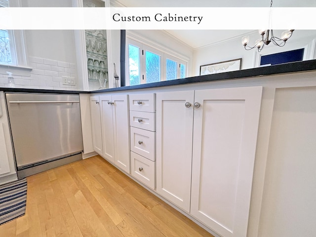 kitchen featuring stainless steel dishwasher, a chandelier, light wood-type flooring, white cabinetry, and dark countertops