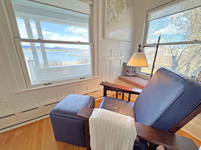 sitting room with wood finished floors and a water view