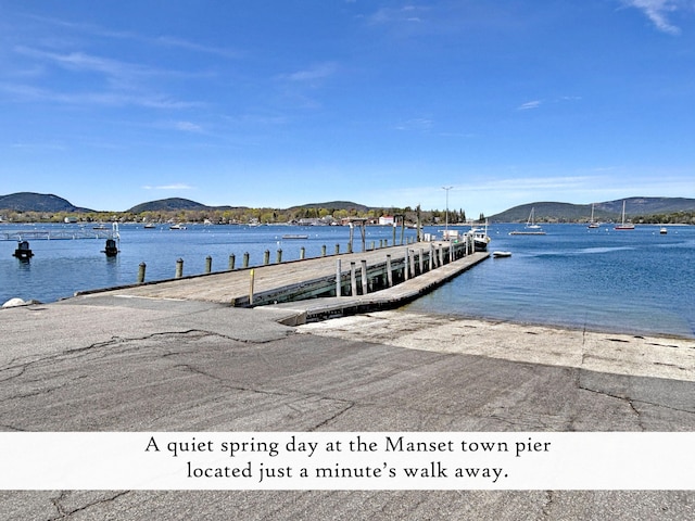 dock featuring a boat ramp and a water and mountain view