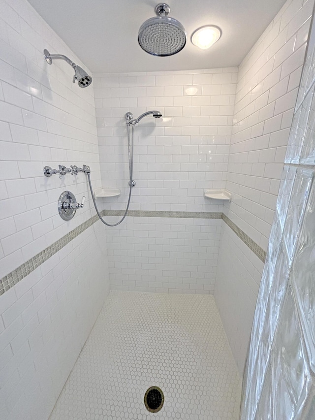 bathroom with a tile shower