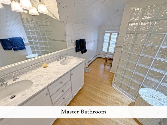 full bathroom featuring wallpapered walls, baseboard heating, wood finished floors, walk in shower, and lofted ceiling