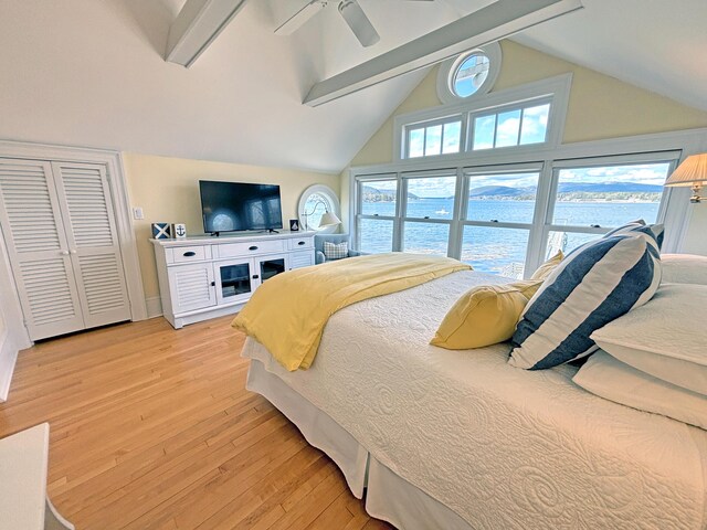 bedroom featuring light wood-style flooring, beam ceiling, ceiling fan, and high vaulted ceiling