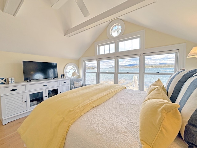 bedroom with a water view, beam ceiling, a ceiling fan, and high vaulted ceiling