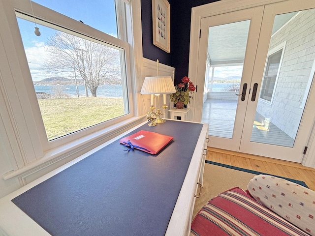 office featuring french doors and a water view