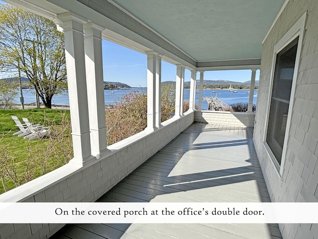 wooden deck with a water view