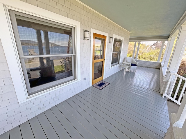 wooden terrace featuring covered porch
