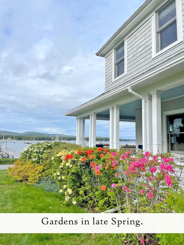 view of side of home with a water view