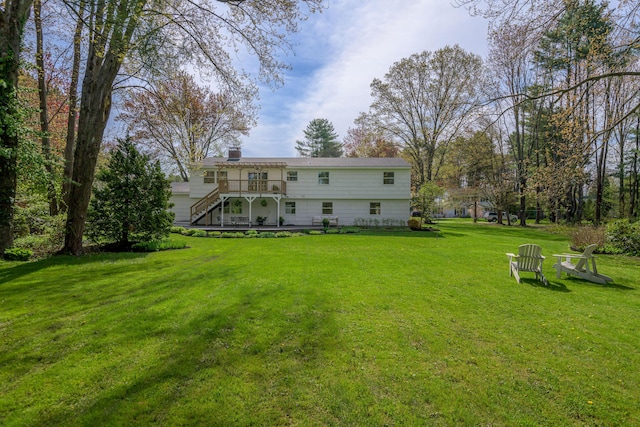 56 Carroll St, Falmouth, ME 04105 - back of property with stairway, a deck, a lawn, and a chimney