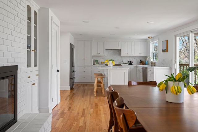 56 Carroll St, Falmouth, ME 04105 - dining room with light wood-type flooring, a fireplace, and recessed lighting