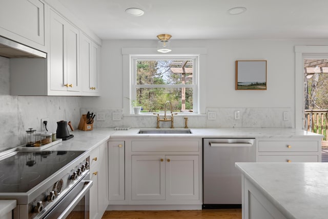 56 Carroll St, Falmouth, ME 04105 - kitchen featuring stainless steel appliances, a sink, healthy amount of natural light, white cabinetry, and recessed lighting