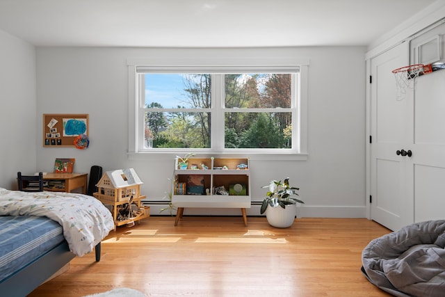 56 Carroll St, Falmouth, ME 04105 - bedroom featuring multiple windows, light wood-style flooring, baseboards, and a baseboard radiator