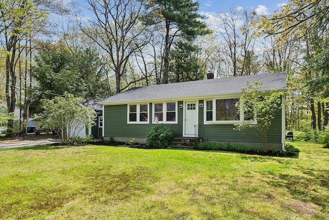 38 Falmouth Rd, Falmouth, ME 04105 - view of front of home with entry steps, a front yard, a chimney, and roof with shingles