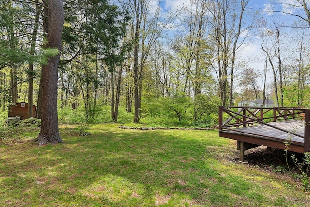 38 Falmouth Rd, Falmouth, ME 04105 - view of grassy yard with a wooden deck, an outdoor structure, and a storage shed