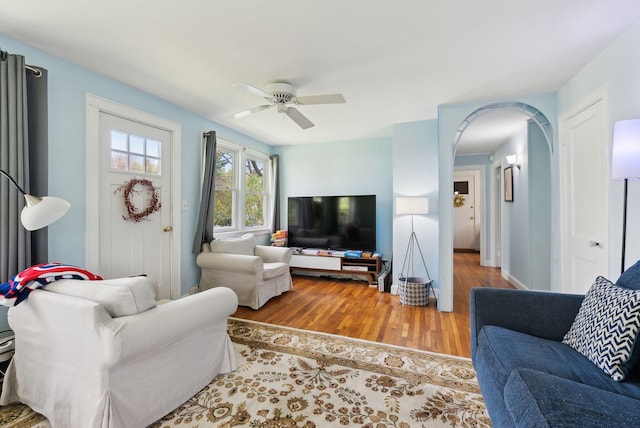 38 Falmouth Rd, Falmouth, ME 04105 - living room featuring wood finished floors, a ceiling fan, and arched walkways