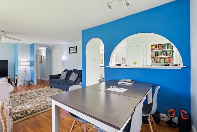 38 Falmouth Rd, Falmouth, ME 04105 - dining area featuring arched walkways, wood finished floors, a ceiling fan, and baseboards