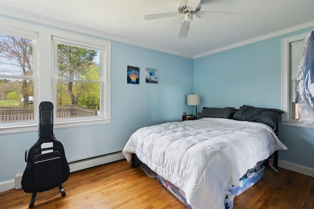 38 Falmouth Rd, Falmouth, ME 04105 - bedroom with a baseboard heating unit, crown molding, wood finished floors, and a ceiling fan