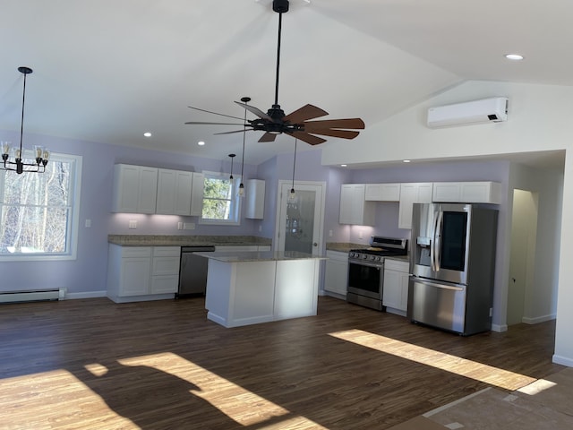 kitchen featuring stainless steel appliances, a baseboard heating unit, an AC wall unit, ceiling fan, and vaulted ceiling