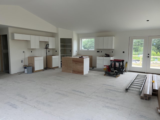 45 Knoll Rd, Poland, ME 04274 - kitchen with lofted ceiling, white cabinetry, french doors, and a kitchen island